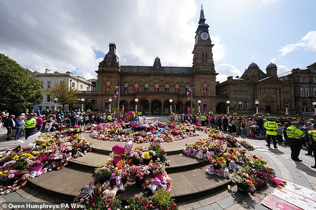 Balloons and floral tributes were left as residents paid their respects to the three young girls last year
