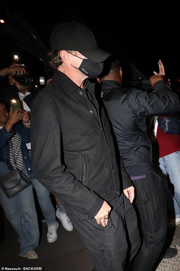 Excited fans watched as DiCaprio was escorted to a nearby SUV by a well-dressed bodyguard