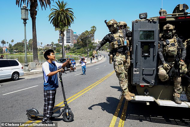 Agents were seen driving through the streets in armored tanks, stopping people and asking for identification along the way (pictured)