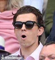 Tom Holland reacts to the action court-side