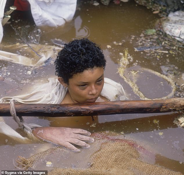 A child floats in muddy water after being caught in the lahar that was triggered by the 1985 eruption of the Nevado del Ruiz volcano in Columbia