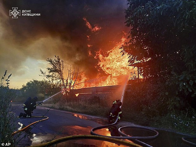 Firefighters put out the fire following a Russian attack in Kyiv region, Ukraine, Wednesday, July 9, 2025