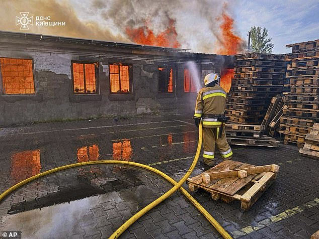 A firefighter puts out the fire following a Russian attack in Kyiv region, Ukraine, Wednesday, July 9, 2025