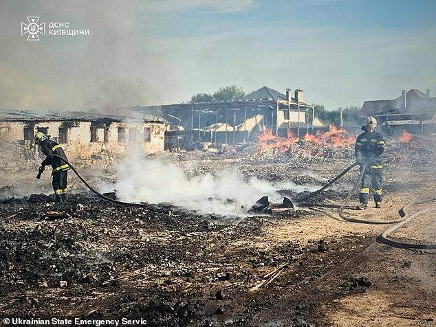 This handout photograph taken and released by Ukrainian State Emergency Service on July 9, 2025, shows firefighters extinguishing a fire after a Russian attack in Kyiv region, amid the Russian invasion of Ukraine