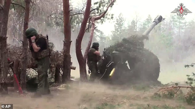 Russian soldiers fire from D-30 howitzer towards Ukrainian positions in an undisclosed location in Ukraine