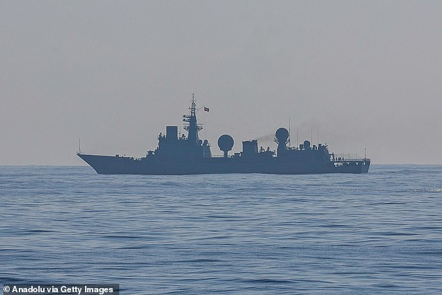 A Chinese warship is seen sailing near several Philippine and United States Navy vessels partaking in a multilateral maritime exercise