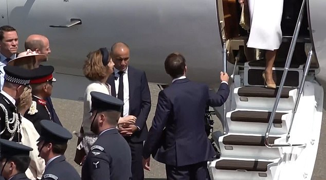 French President Emmanuel Macron offers a hand to his wife Brigitte at RAF Northolt yesterday