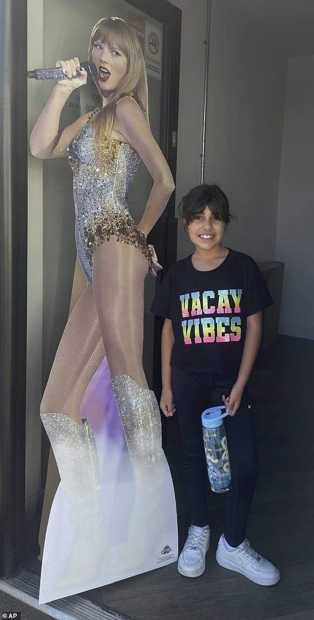Alice da Silva Aguiar, nine, with a cardboard cutout of her pop hero before the fatal attack