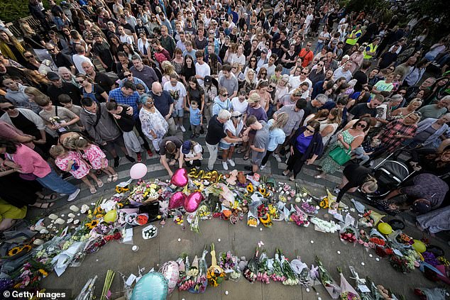 Locals hold a vigil outside the art centre in rememberance of Elsiie Dot, Alice and Bebe following the attack on the dance school in Southport last July