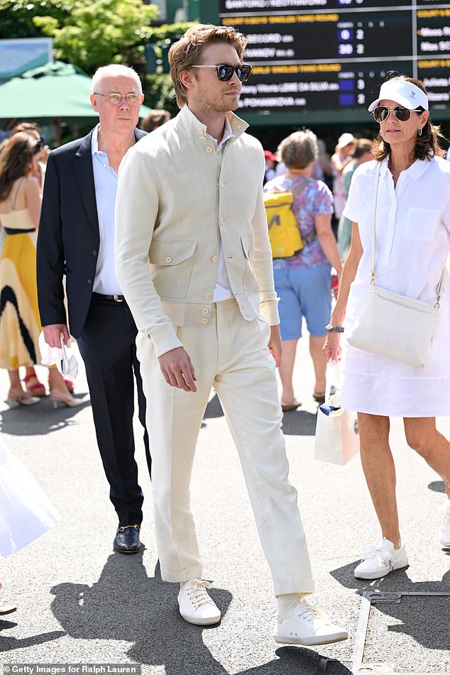 Taylor Swift's ex Joe cut a dapper figure in an off-white jacket and matching trousers