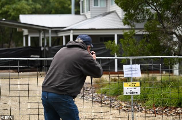 A photographer zooms in on a note Patterson's supporters had pinned outside her home in anticipation of her walking free
