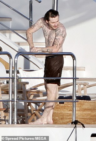Tattooed Brooklyn showed off his torso in swimming shorts