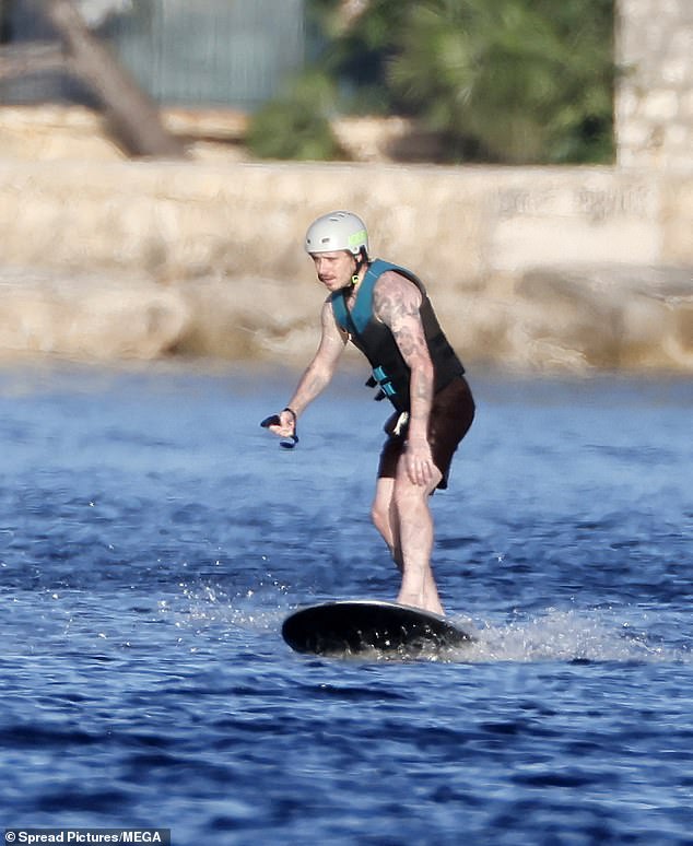 While Nicola soaked up the sun on the boat, Brooklyn was spotted larking about on the water on an E Foil, which is a watercraft that combines surfing, hydrofoiling and electric propulsion