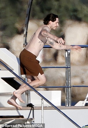 Brooklyn was wearing a pair of brown swim shorts