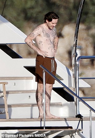 Brooklyn was wearing a pair of brown swim shorts