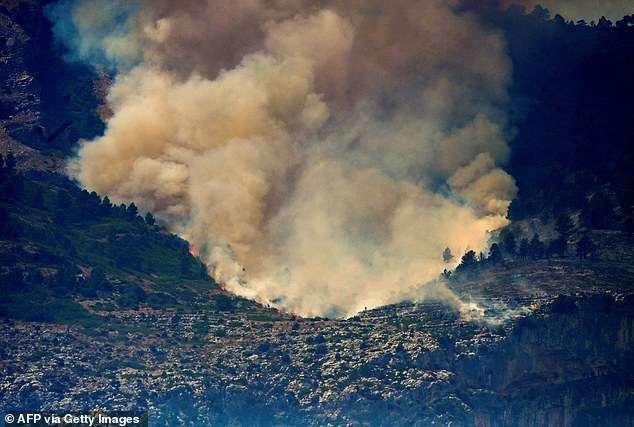 Smoke billowing from a forest fire near Pauls, next to Tarragona, Spain on Tuesday