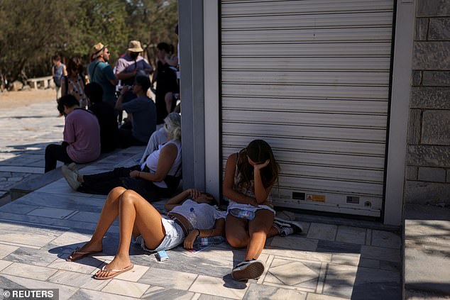 People sit in the shade near the Acropolis, with 40C expected in Greece on Wednesday
