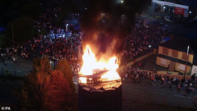 People watch as the pyre with a boat on top was set alight in Moygashel on July 8 2023