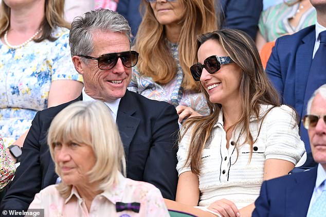 Paddington actor Hugh Grant, 62, and his Swedish wife Anna Eberstein, 46, share a joke as the matches get underway