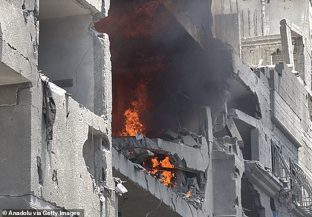 Flame rises from a commercial building after a fire broke out following Israeli airstrike in Omar Mukhtar Road in Gaza City, Gaza on July 09, 2025
