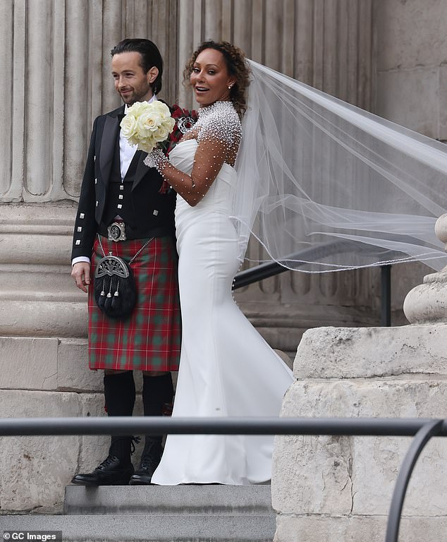 Mel stunned in her elegant pearl-studded gown as she and Rory posed for snaps together after being declared husband and wife