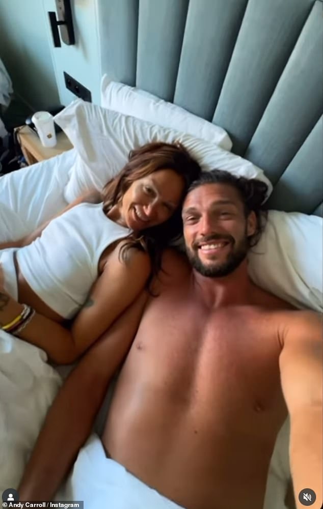 The pair posed for a photo in bed, before sharing a kiss on a sun lounger and enjoying a day at the beach
