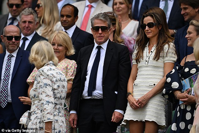 Hugh and Anna stood up with the crowd as they welcomed Queen Camilla onto Centre Court
