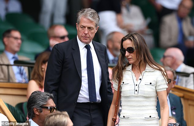 Hugh kept things basic in a navy suit and tie while Anna rocked a Chanel-inspired tweed dress