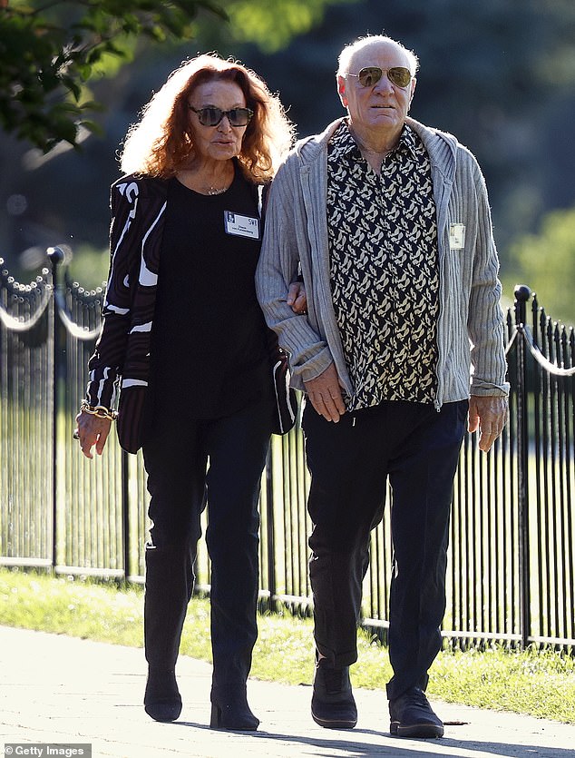 Dressed for the wrong season! Chairman and senior executive of IAC and Expedia group Barry Diller, 83, and his wife fashion designer Diane von Fusternberg, 78, were seen walking arm-in-arm on Wednesday to a morning session at the retreat. However, they looked like they were dressed for the entirely wrong season, as DVF wore an all-black ensemble topped with a white and black patterned coat, while her husband wore black jeans, a black patterned shirt and a gray rib-knit hoodie