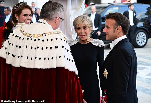 The French First Lady, 72, for the occasion, opted for a sleek black gown with statement silver shoulder detailing, whereas her husband, 47, was dapper in a tuxedo