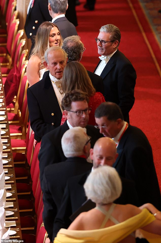 Mary and Keir were pictured enjoying a chat, as other attendees at the event mingled, at Windsor Castle