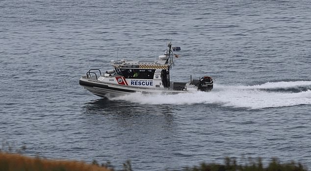 Marine rescue crews (above) worked into the night looking for Darcy on Wednesday