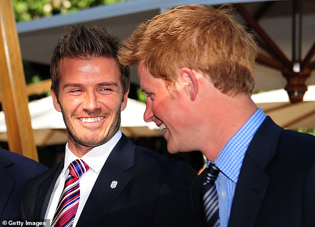 Prince Harry smiles with David Beckham at an FA reception in South Africa in 2010