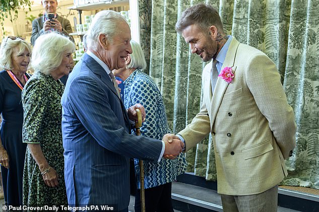King Charles, patron of the Royal Horticultural Society, shakes hands with Beckham during a visit to the RHS Chelsea Flower Show in May 2025