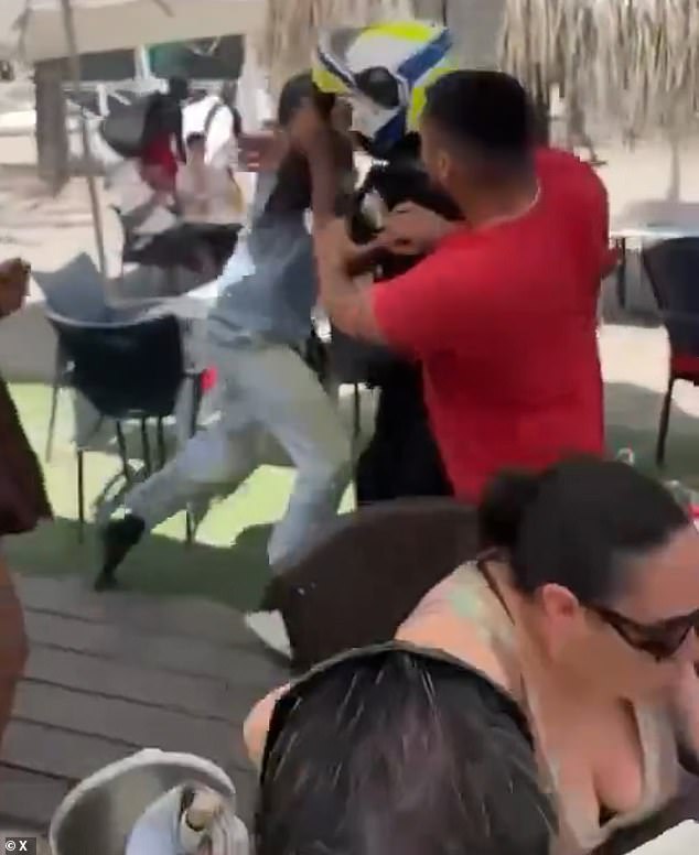 One vendor appeared to have broken part of the officer's helmet while punching him in the face
