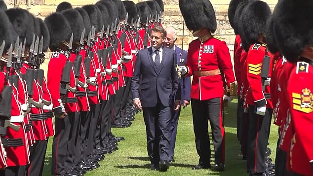 Macron was compared to Donald Trump as he was seen strolling ahead of the monarch while reviewing the Grenadier Guards and Scots Guards
