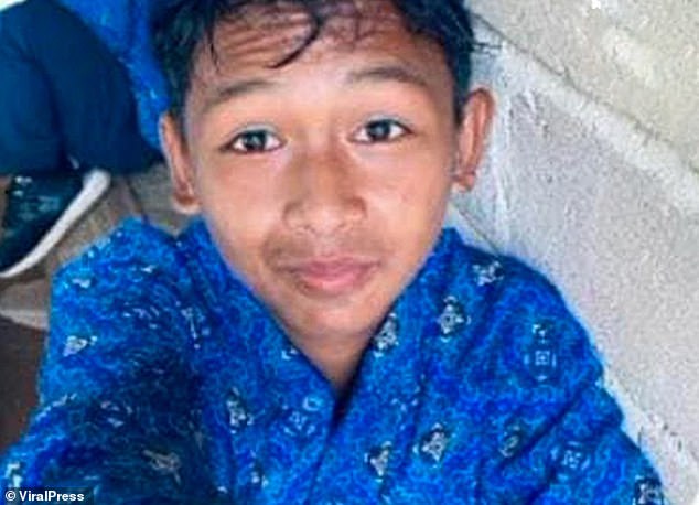 Muhammad Nur Akbar (pictured) was with his friends at the Santan Ulu River in East Kalimantan on Tuesday