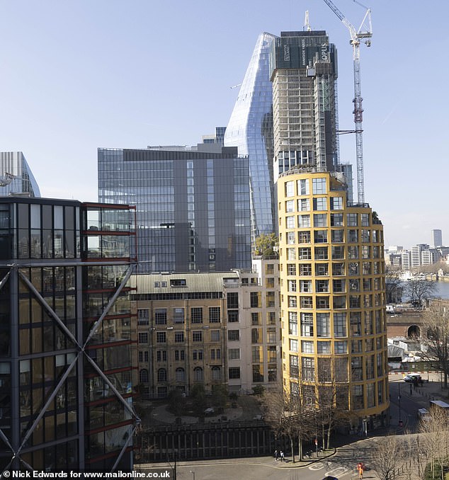 The couple's flat is located in the round building on the right of this image. The office block is the rectangular glass structure just to the left of it