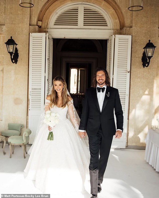 The blushing bride, 40, stunned in an off-the-shoulder wedding gown with a racy sweetheart neckline designed by South Australian fashion designer Paul Vasileff