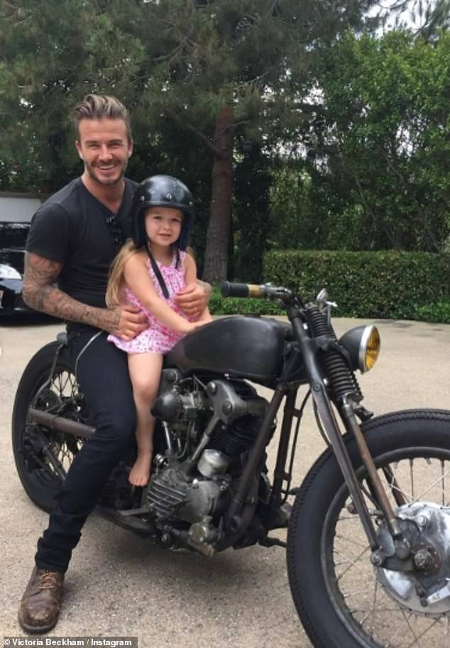 Victoria shared an adorable photo of Harper perched on a motorbike with her father David