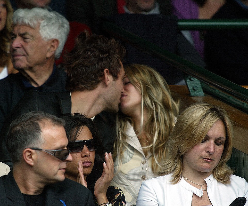 Actor Jude Law and his girlfriend Sienna Miller kiss in the Royal Box at Wimbledon, 2004