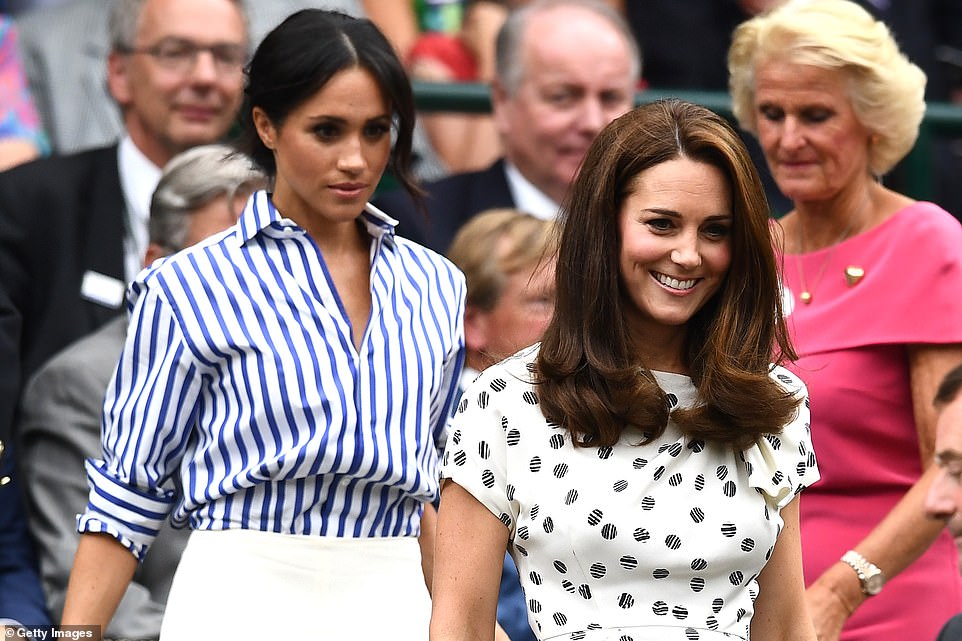 Kate beams as she makes her way to her seat at Wimbledon with Meghan Markle, Duchess of Sussex, in 2018