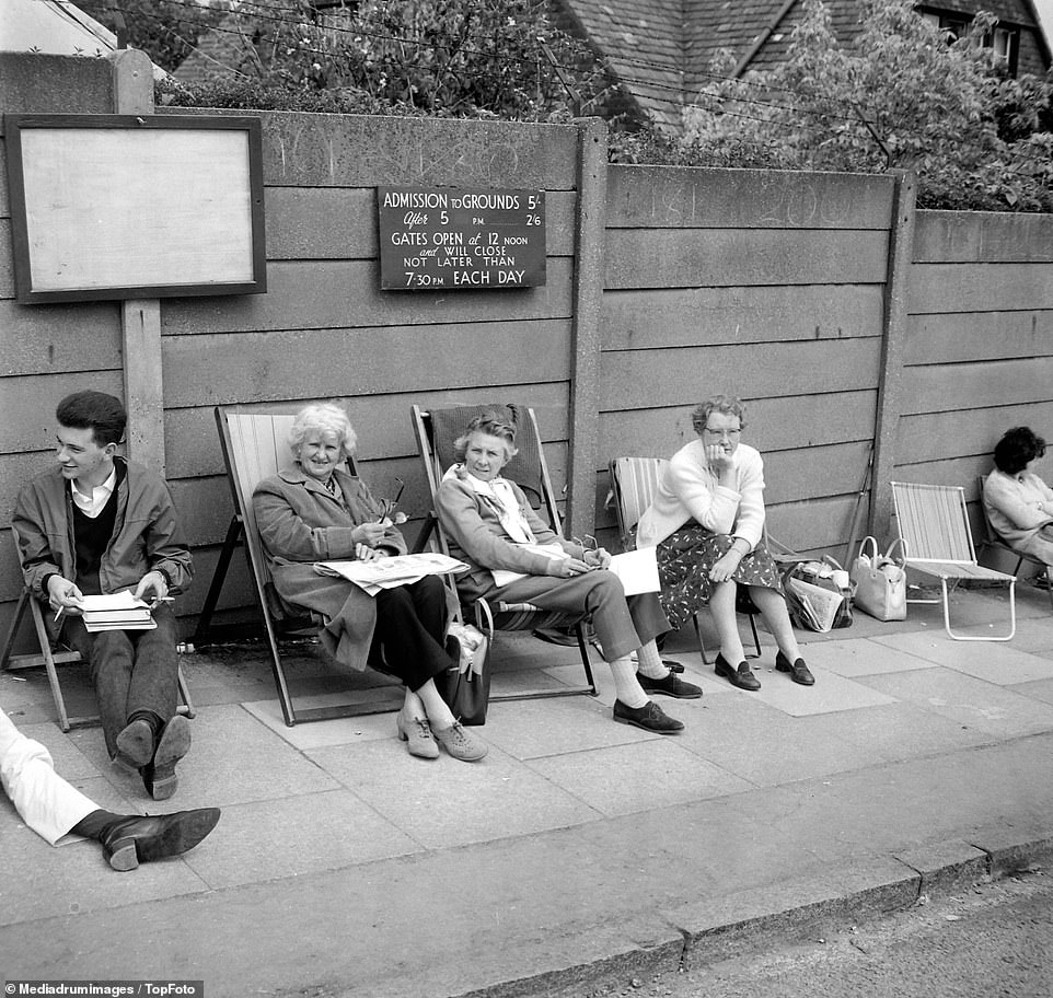 Deck chairs at the ready: Spectators seen sitting down outside Wimbledon as they wait for the gates to open, July 1962