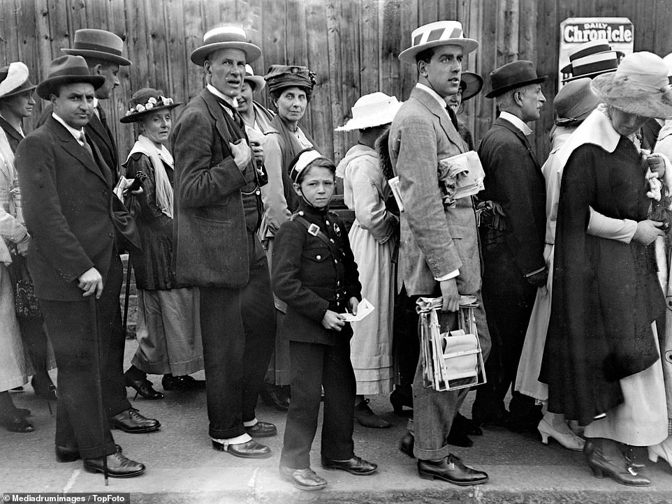 A messenger boy seen hard at work amidst a queue of people at Wimbledon, 1919