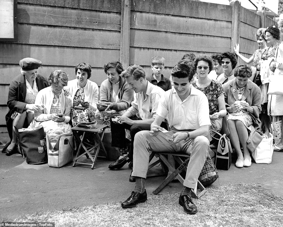 Spectators prepared to wait for hours are seen sitting down while queuing to get into Wimbledon, July 1962