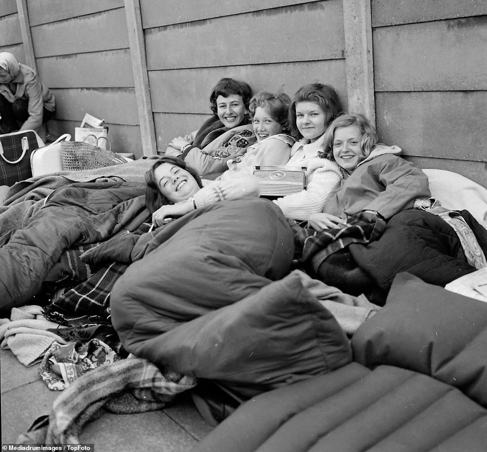 Excitable spectators seen posing for a group photo as they wait to get into Wimbledon, July 1960