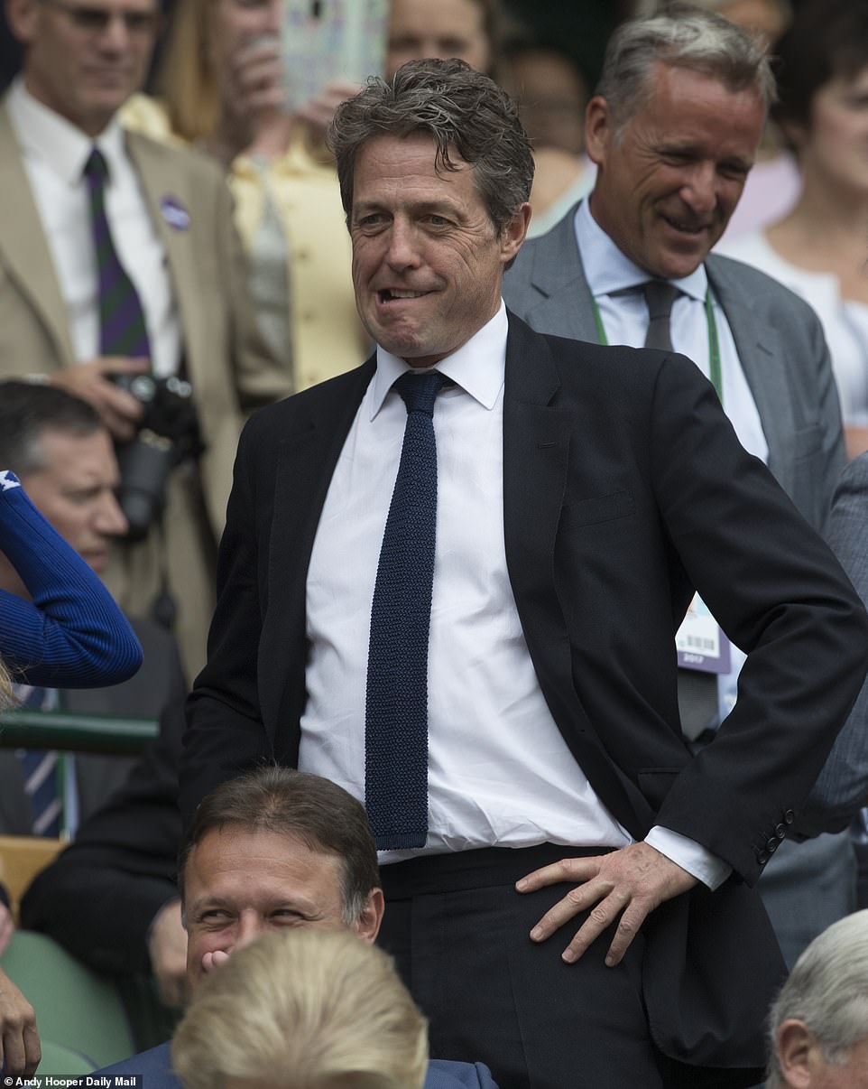 Hugh Grant gives one of his characteristic nonchalant expressions while in the Royal Box at Wimbledon, 2017