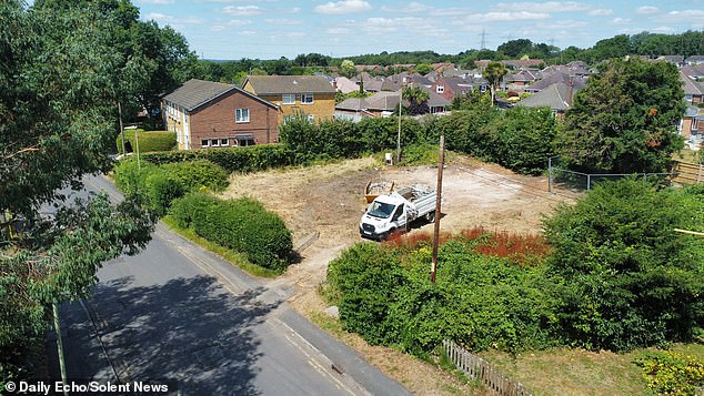 Villagers have been left 'stunned' after the beautiful thatched cottage was 'smashed' down in just one hour without planning permission (Pictured: Workers on site after it was demolished)