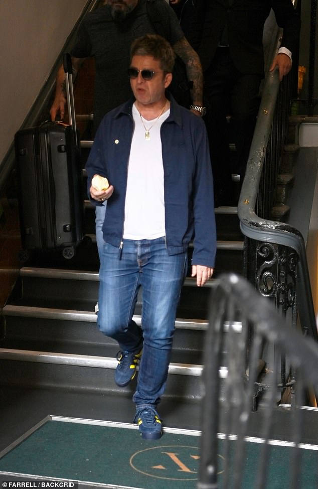 On his feet he slipped into a pair of navy and yellow Adidas trainers. Oasis recently released new merchandise with the brand ahead of the Oasis Live '25 tour