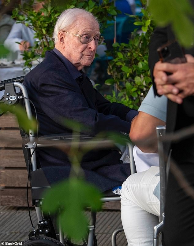 The 92-year-old iconic British actor - who is best known for the films Alfie and Batman Begins - looked dapper in a black suit and dark blue shirt with comfortable lace-free black shoes